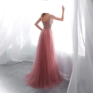 Back view of pink evening gown featuring sequined bodice and flowing mesh skirt
