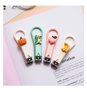 Set of four cute cartoon nail clippers with pumpkin, dinosaur, peach and banana designs