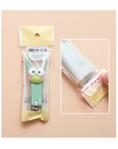 Detailed view of a green cartoon frog nail clipper with stainless steel blade and packaging