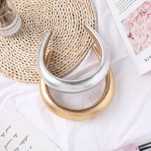 Detail shot of padded metallic gold and silver leather headbands on a stylish background