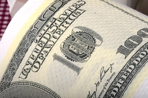 Close-up of novelty toilet paper roll with detailed 100 dollar bill pattern printing