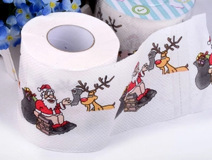 Detail shot of Christmas toilet paper featuring Santa Claus and reindeer cartoon patterns