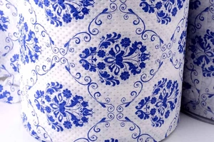 Detailed view of rolled tissue paper featuring classic blue and white floral porcelain pattern
