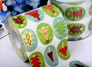 Detail shot of Christmas toilet paper featuring printed red and yellow holiday trees