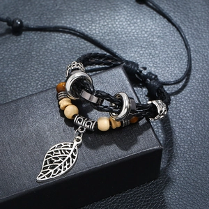 Detail of multi-layer beaded leather bracelet featuring a hollow leaf pendant and drawstring