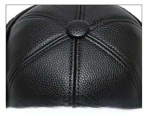 Macro shot of black textured faux leather baseball cap with reinforced six-panel stitching