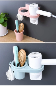 Detail of wall-mounted hair dryer holder with comb bucket and hooks for bathroom storage