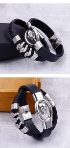 Detail of black braided leather bracelet featuring a silver skull and metal plug buckle