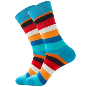 Detail of colorful rainbow striped crew socks with elastic ribbed cuffs and cotton knit texture