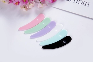Set of six colorful plastic cosmetic spatulas for facial masks and creams in various shades