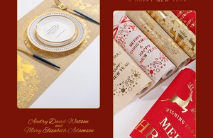 Detail of Christmas table runner with golden reindeer and snowflake prints on linen fabric