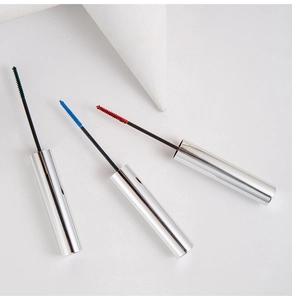 Detailed macro view of colorful mascara brushes in green, blue, and red with silver cases