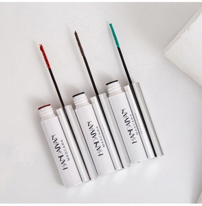 Detailed shot of red, brown and green mascara wands with white tubes on white background