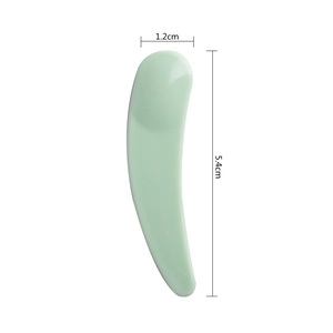 Macro view of light green facial cream spatula with 1.2cm width and 5.4cm length dimensions