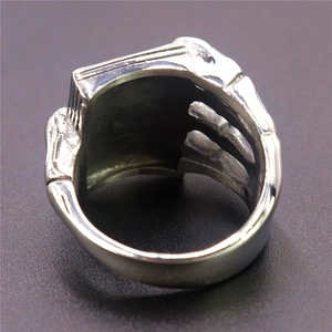 Gothic stainless steel skull ring with spade hand design shown from back and inner band