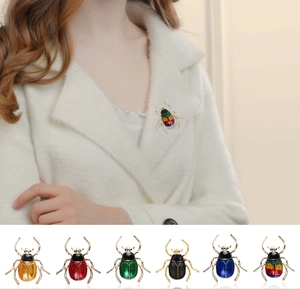 Detailed view of the vintage enamel beetle brooch, showing exquisite craftsmanship and rich colors.