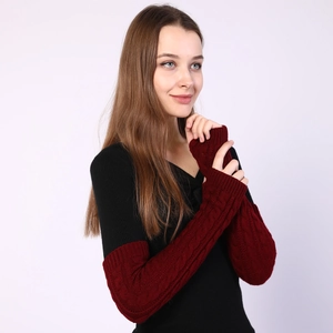 Detailed close-up of wine red cable knit long fingerless gloves with thick texture