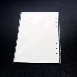 Macro detail of white 6-hole binder paper refills for A4 A5 A6 A7 notebook molds