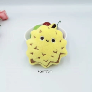 Close-up of yellow plush durian keychain with 7cm size measurement and soft spikes