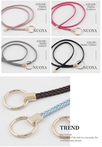 Detail of woven thin belt with elegant round golden buckle for summer dresses