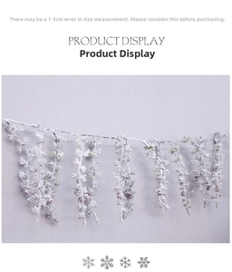 Detailed view of artificial frosted cedar branch with pine cones for Christmas decor