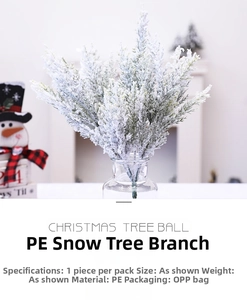 Detail view of artificial cedar branch with realistic snow frost for Christmas decor
