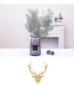 Detail of silver frosted pine branches in a gray glass vase for Christmas decor