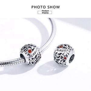 Detailed S925 sterling silver hollow bead with red gemstones and January engraving