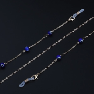 Silver chain eyewear strap featuring blue evil eye beads and lobster clasps for glasses