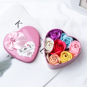Close-up of heart-shaped pink tin box with 6 soap roses and a satin ribbon bow