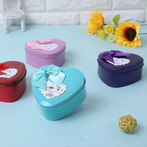 Detail of heart-shaped tin gift boxes with soap roses and elegant silk ribbons