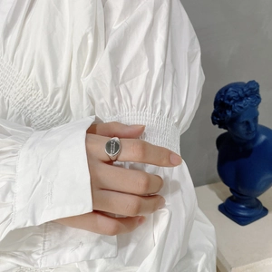 Detailed close-up of oval silver signet ring with some kind of wonderful engraving