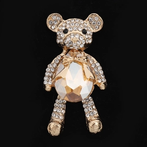 Detail of a gold bear brooch featuring champagne crystals and white rhinestones