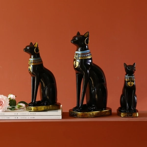 Three Egyptian cat statues in matte black and gold finish as exotic resin bookends