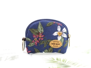 Detail of floral cotton coin purse showing textile texture and handmade leather label