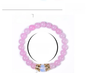Detail of pink crystal beaded bracelet with copper zircon crown charm and 8mm beads