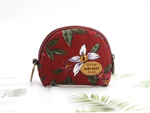 Detail of vintage floral cotton coin purse with leather label and bronze ring zipper