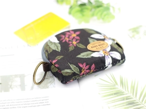 Detailed view of handmade floral cotton coin purse with vintage bronze metal ring zipper