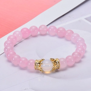 Pink quartz and hematite beaded bracelet with a zircon-inlaid gold crown charm