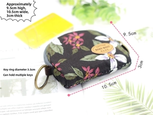 Floral fabric coin purse with semicircular design and metal keyring detail