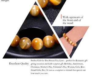 Macro detail of yellow tiger eye stone beads bracelet with distinct golden chatoyancy