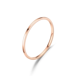 Detailed macro shot of a minimalist 1mm rose gold titanium ring with a polished surface
