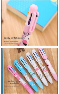 Detail of multi-color cartoon pens with unicorn and flamingo patterns on a wooden desk
