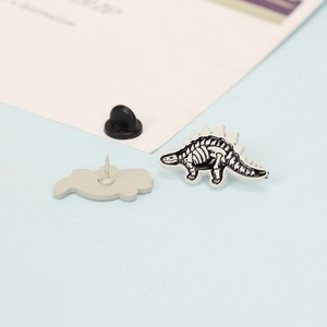 Black and white stegosaurus dinosaur skeleton enamel pin with secure rubber clutch back