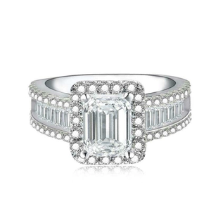 Close-up of emerald cut cubic zirconia ring with sparkling halo setting and pavé band