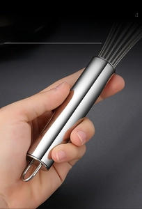 Polished stainless steel whisk handle with a round grip and hanging loop detail