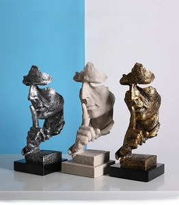 Three Nordic silence is golden sculptures in bronze, sandstone and silver-black resin finish