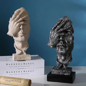 Nordic resin 'Silence is Golden' sculptures in sandstone and grey on book stands