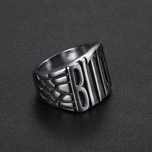 Vintage stainless steel BITCH letter ring with snake skin texture on grey background