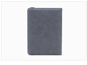 Detail of slim RFID passport holder showing premium matte leather texture and fine stitching